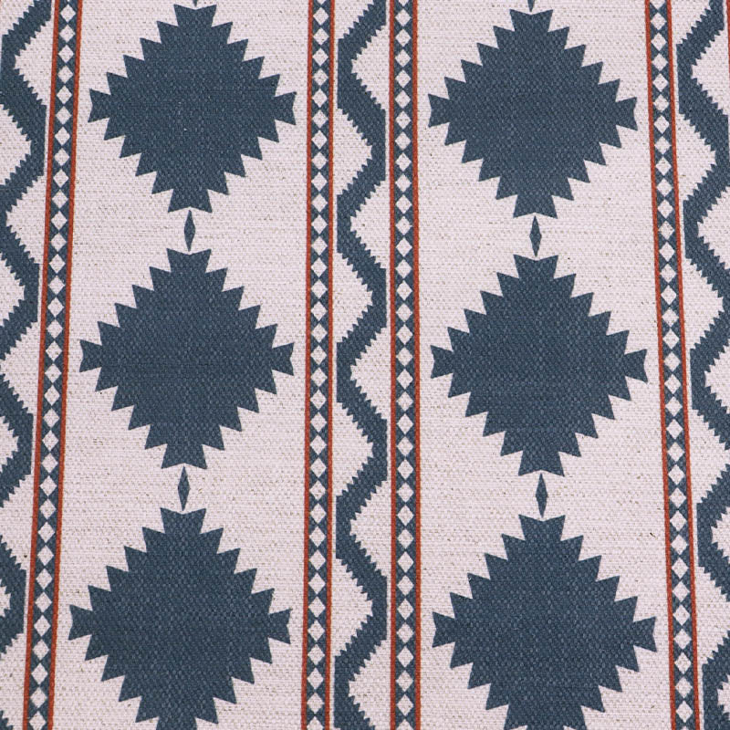 Linen and viscose blend furnishing fabric in a bold diamond shaped geometric print in petrol blue with red lines on a cream background.