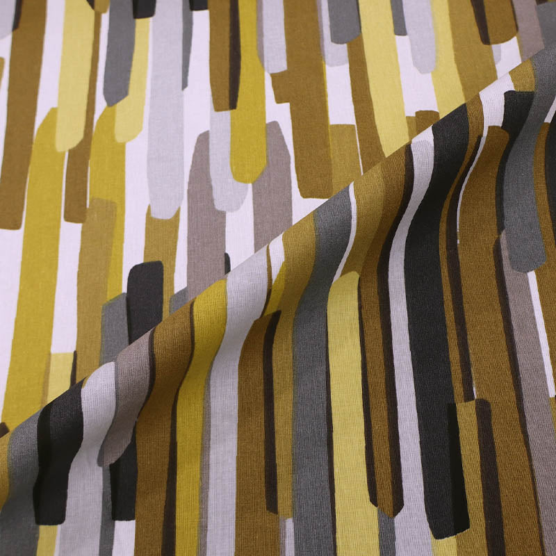 100% Cotton Great Value Cotton Fabric with vertical stripes almost like brush strokes in brown, yellow, grey and black on a white background.