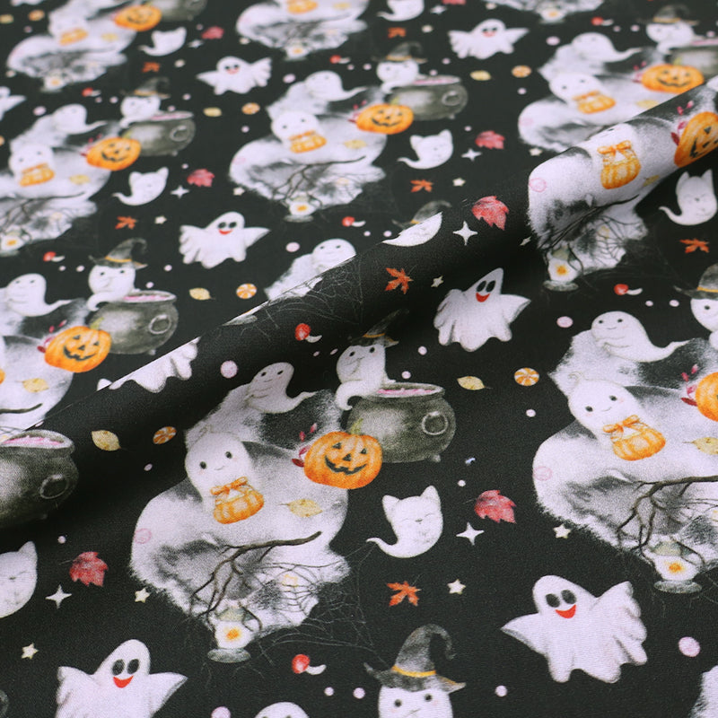 Halloween-themed fabric with ghosts, pumpkins, and cats on a black cotton background.