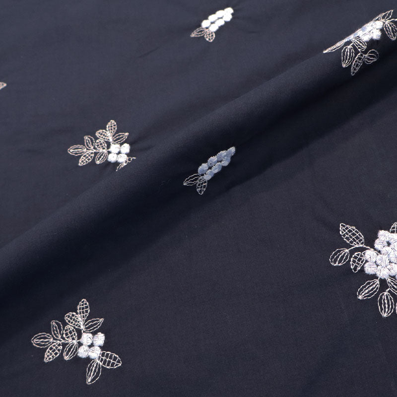 100% Cotton Embroidered Cotton Floral Fabric featuring pale blue floral and leaf motifs on a dark blue light weight cotton base cloth