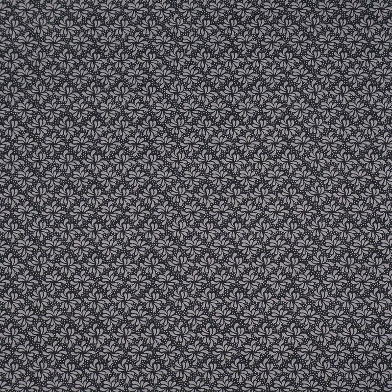 100% Cotton Geometric Fabric - Black and Grey with a small grey geometric leaf print on a solid black background.
