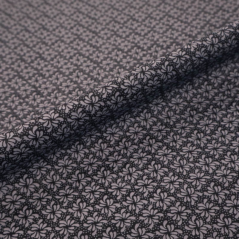 100% Cotton Geometric Fabric - Black and Grey with a small grey geometric leaf print on a solid black background.