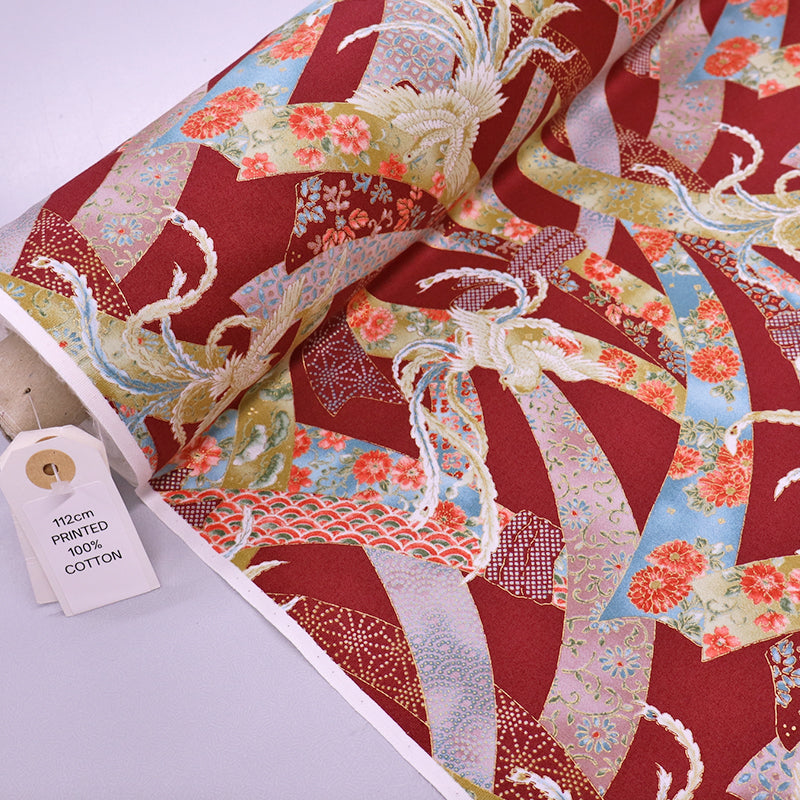 Japanese fabric featuring an intricate design of doves and floral ribbons on a rust red background. In 100% cotton