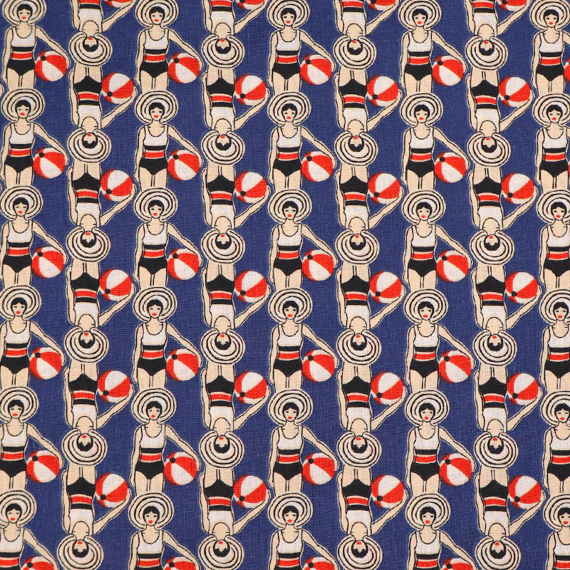 Patterned fabric with women in swimsuits and beach balls on a blue background