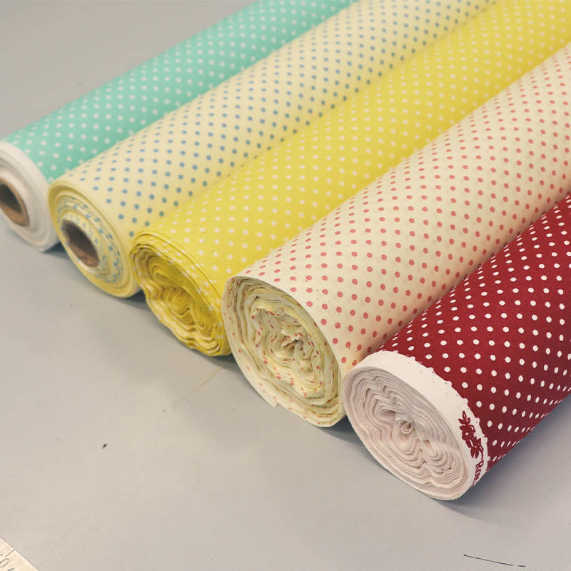 Rolls of cotton polka dot fabric in various colours 