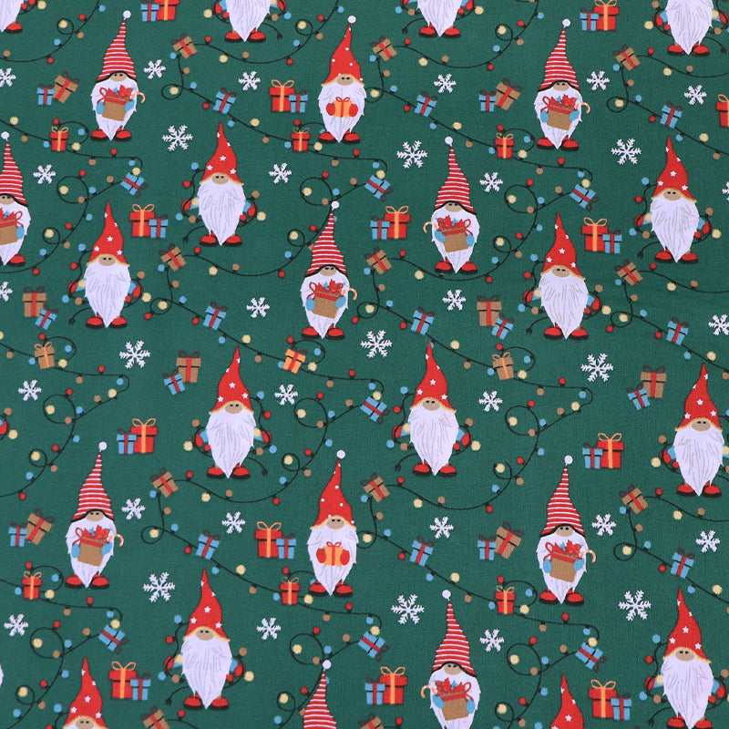Christmas-themed 100% cotton fabric with gnomes and snowflakes on a green background