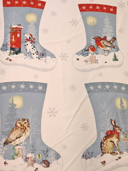 100% cotton Christmas-themed stocking panel fabric prints featuring four stocking illustrations with winter animals and snowy scenes with light snowflake motifs.