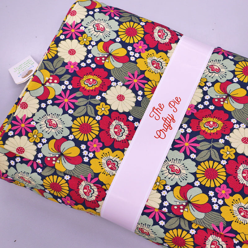 95% Cotton 5% Elastane  pink floral jersey fabric by The Crafty Pie featuring a pink, red, yellow and blue floral print