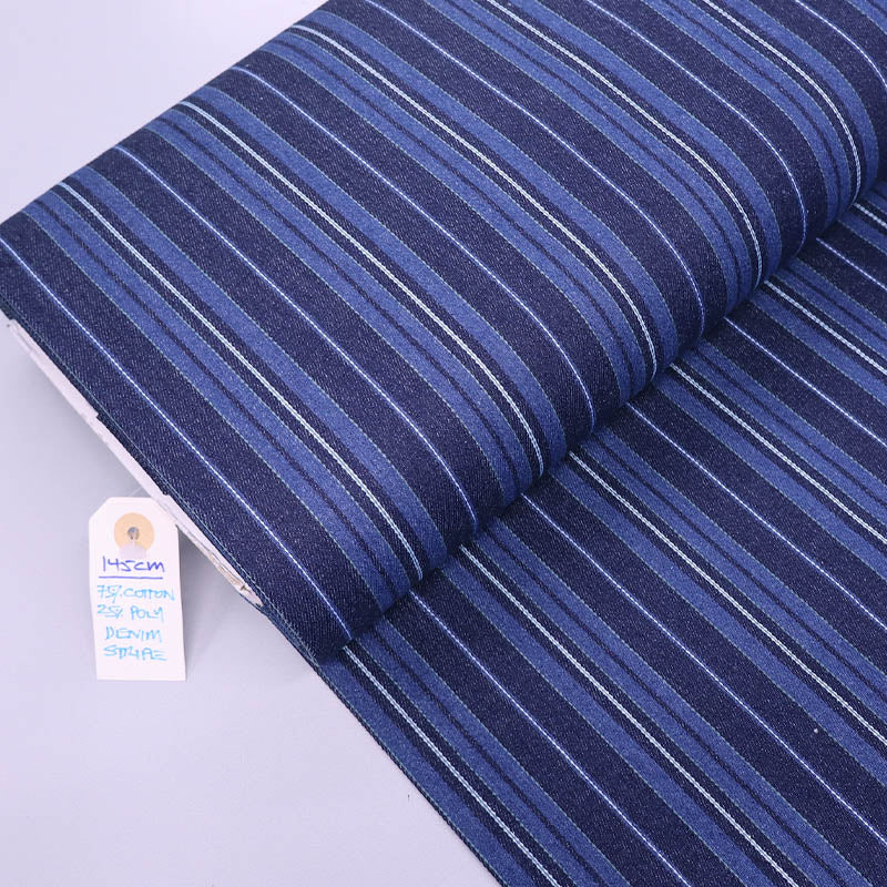 Dark blue striped denim fabric  75% Cotton 25% Polyester denim fabric with different blue coloured stripes of varying widths. 