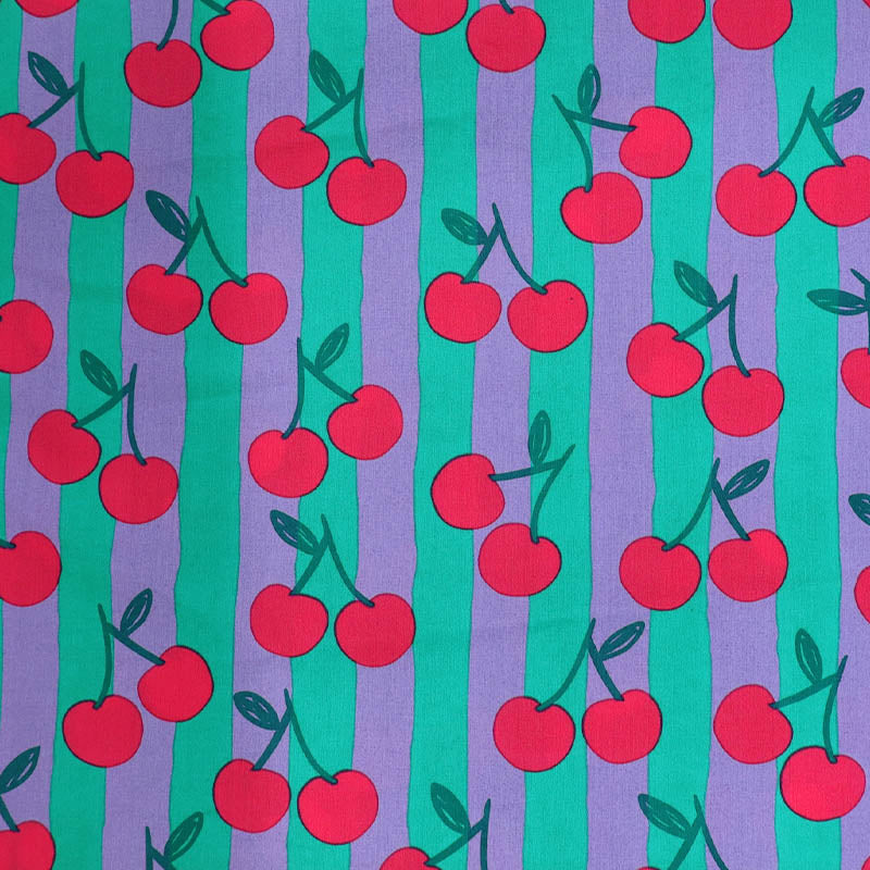 100% Cotton Poplin Fabric - Cherry Print
with red cherry print on a purple and green striped background.