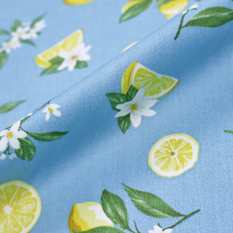 100% Cotton Pale Blue Poplin Fabric - Lemon Print