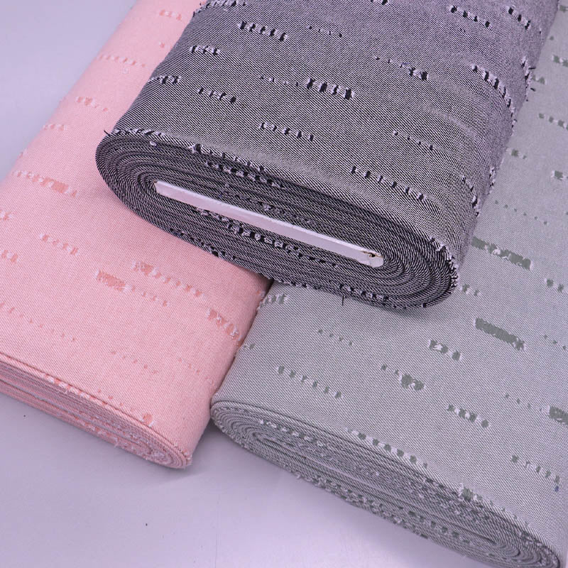 distressed denim fabrics in black, green and pink