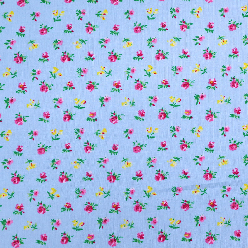 100% Cotton Ditsy Floral Poplin Fabric - small pink and yellow flowers on a pale blue background