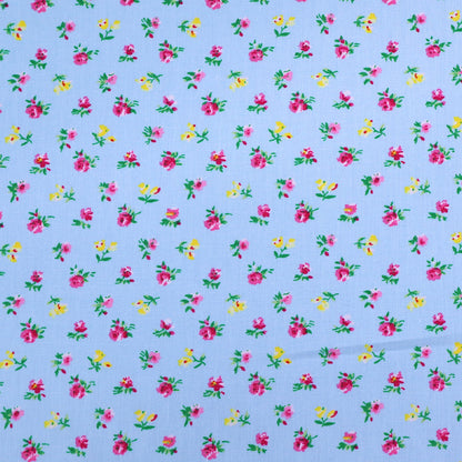 100% Cotton Ditsy Floral Poplin Fabric - small pink and yellow flowers on a pale blue background