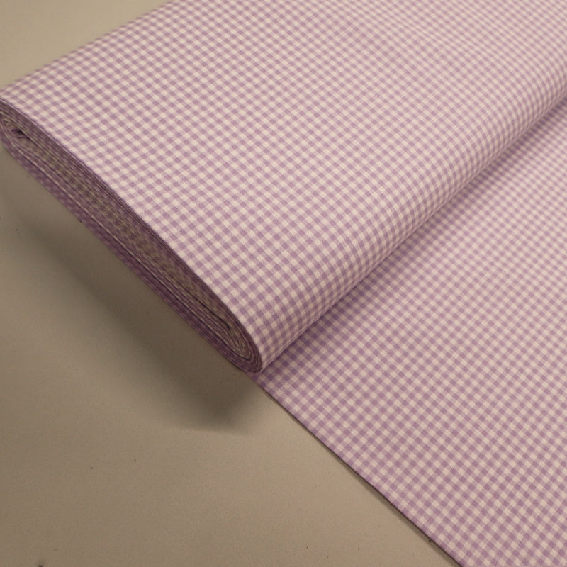 100% Cotton Mini Gingham Dressmaking Fabric featuring a small lilac and white check.
