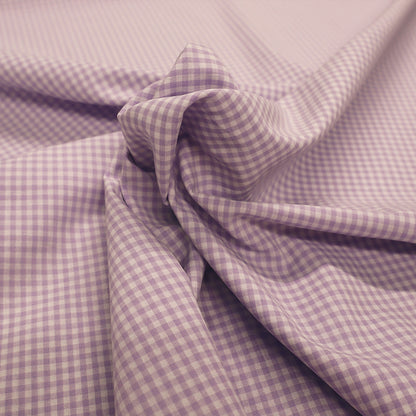 100% Cotton Mini Gingham Dressmaking Fabric featuring a small lilac and white check
