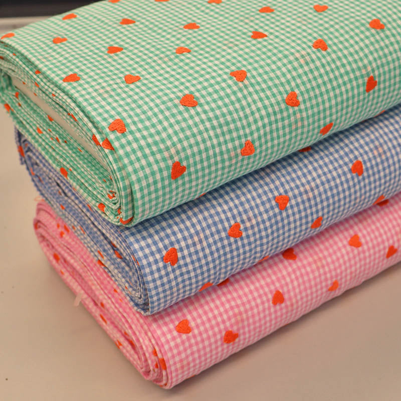 100% Cotton Embroidered Gingham Fabrics in green, blue and pink with orange embroidered hearts 