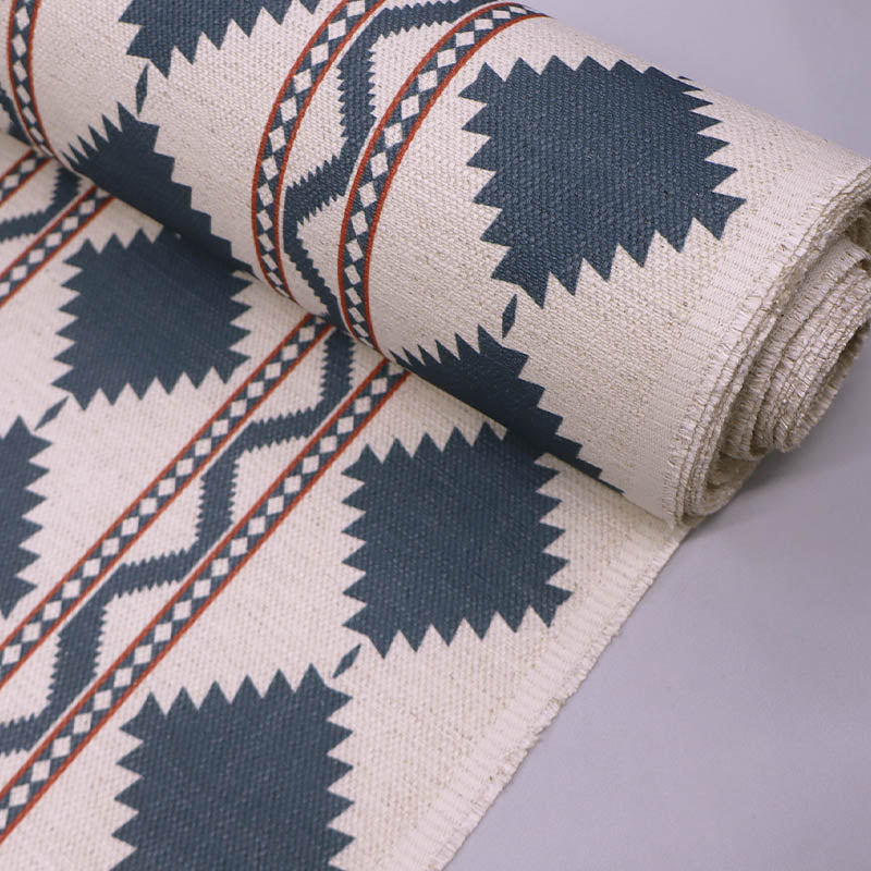  Linen and viscose blend furnishing fabric in a bold diamond shaped geometric print in petrol blue with red lines on a cream background. 