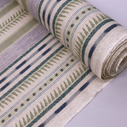 linen blend furnishing fabric featuring an unusual stripe type print in soft green and purple on a cream natural coloured background. 