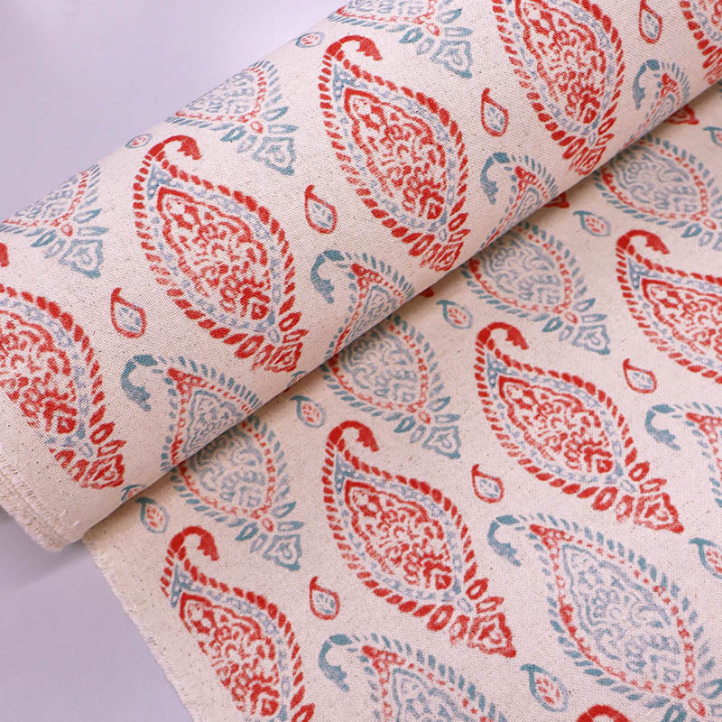 90% Cotton 10% Linen Linen Look Furnishing Fabric - Red & Blue Paisley Print on a cream background