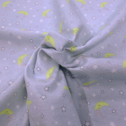 100% Cotton Pale Grey Brushed Cotton Fabric with yellow crescent moons dressed in night caps and with small white stars on a very pale grey background.