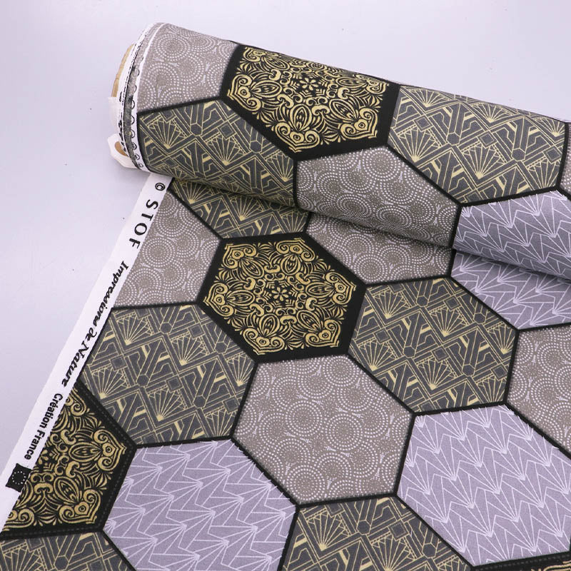 100% Cotton Great Value  Fabric  featuring a grey and cream hexagon print in which 4 different geometric designs are outlined in black.
