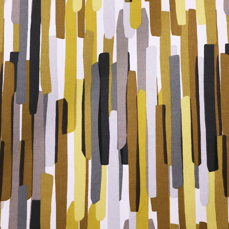  100% Cotton Great Value Cotton Fabric  with vertical stripes almost like brush strokes in brown, yellow, grey and black on a white background. 
