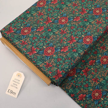100% Cotton Green Metallic Christmas Fabric featuring a traditional winter botanical and floral print in red with teal green leaves on a dark green background.