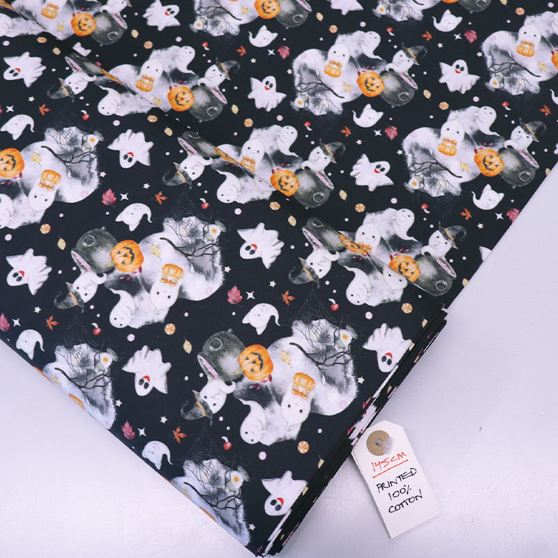 Halloween-themed fabric with ghosts, pumpkins, and cats on a black cotton background.