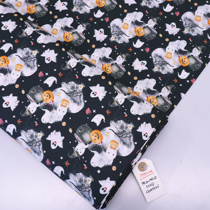 Halloween-themed fabric with ghosts, pumpkins, and cats on a black cotton background.