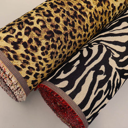 Two rolls of tapestry fabric with leopard print and zebra pattern 