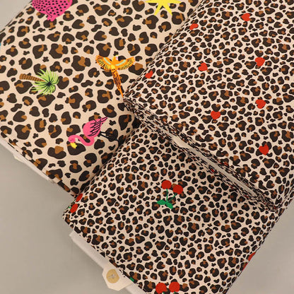 Leopard print jersey fabrics with hearts, cherries and tropical motifs
