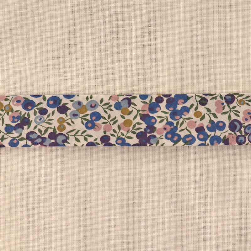 100% Cotton Liberty Fabric Bias Binding in their Wiltshire D design featuring a blue, purple and pink berry print with green stems on a cream background