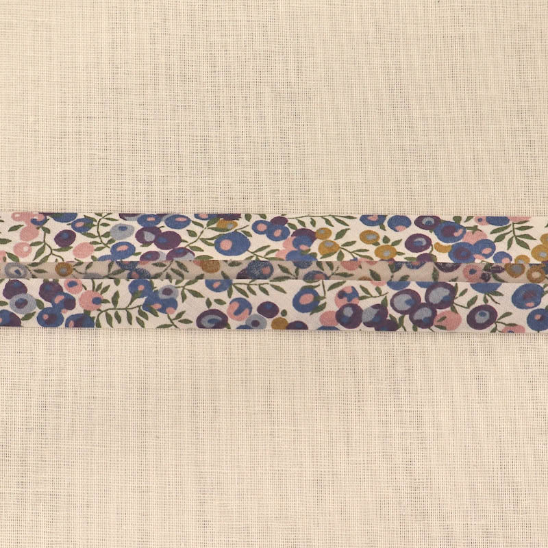 100% Cotton Liberty Fabric Bias Binding in their Wiltshire D design featuring a blue, purple and pink berry print with green stems on a cream background