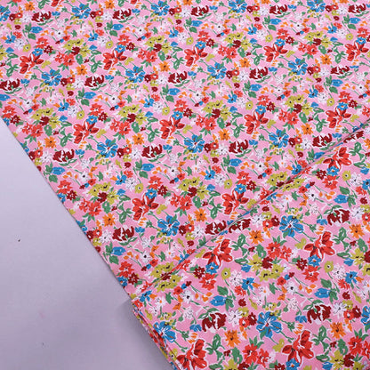 100% Cotton Liberty Cotton Lawn Fabric - Pink Floral featuring a pretty pink, orange, red and blue floral print on a pale pink background. 