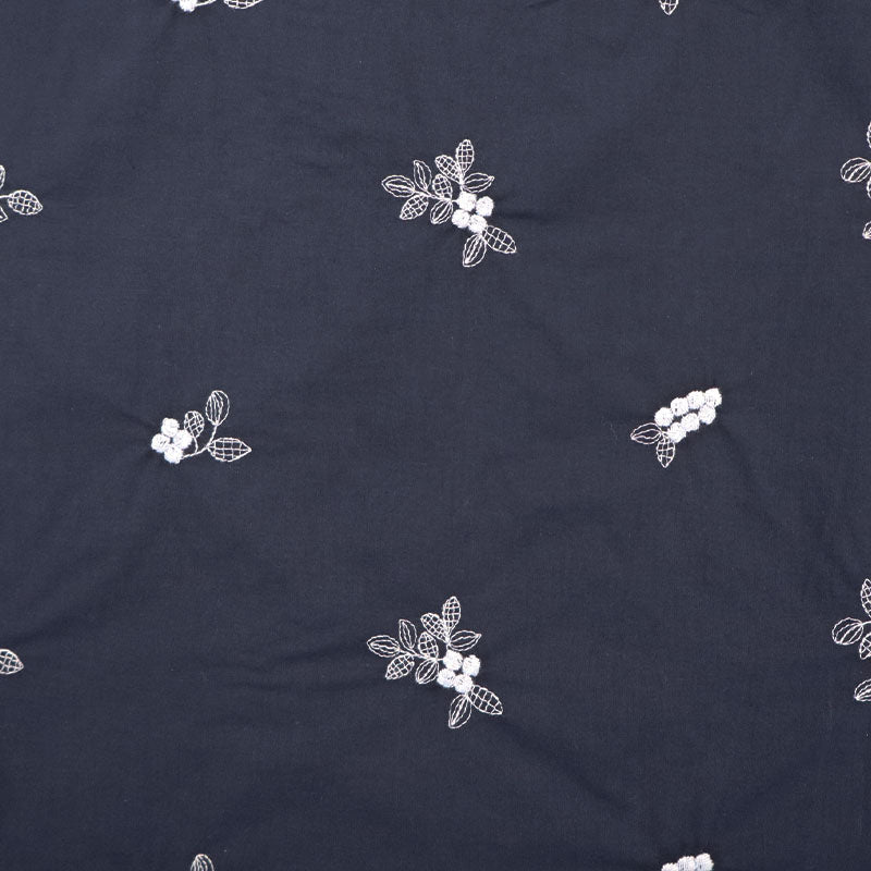 100% Cotton Embroidered Cotton Floral Fabric featuring pale blue floral and leaf motifs on a dark blue light weight cotton base cloth