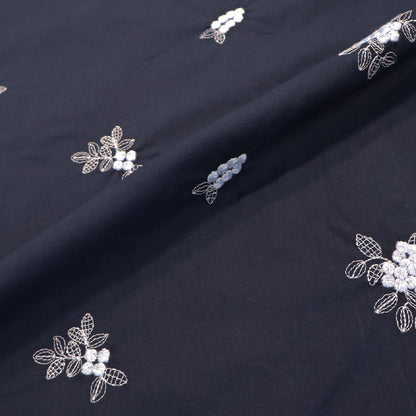 100% Cotton Embroidered Cotton Floral Fabric featuring pale blue floral and leaf motifs on a dark blue light weight cotton base cloth