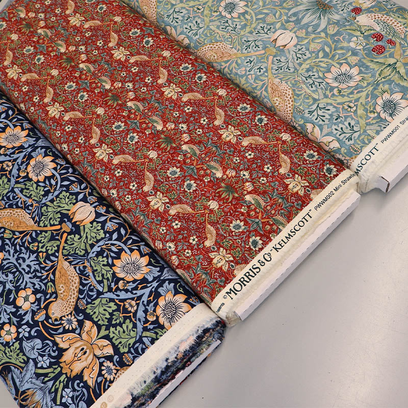 William Morris fabrics Strawberry Thief Design in light blue, dark blue and red