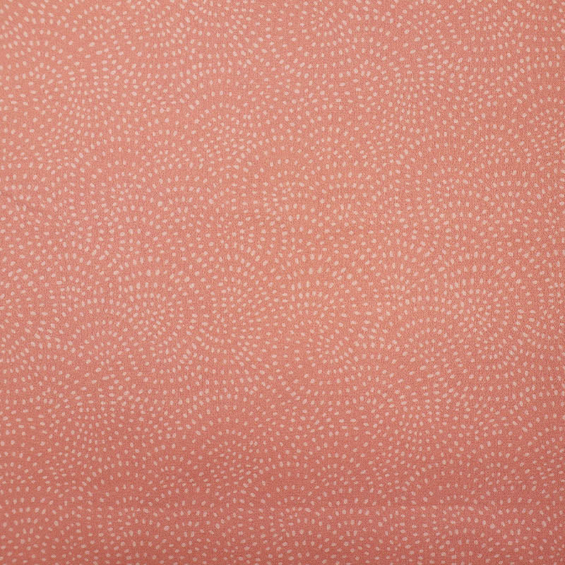 100% Cotton Pale Pink Blender Fabric featuring a subtle print of white spots in a spiral on a pale pink background.