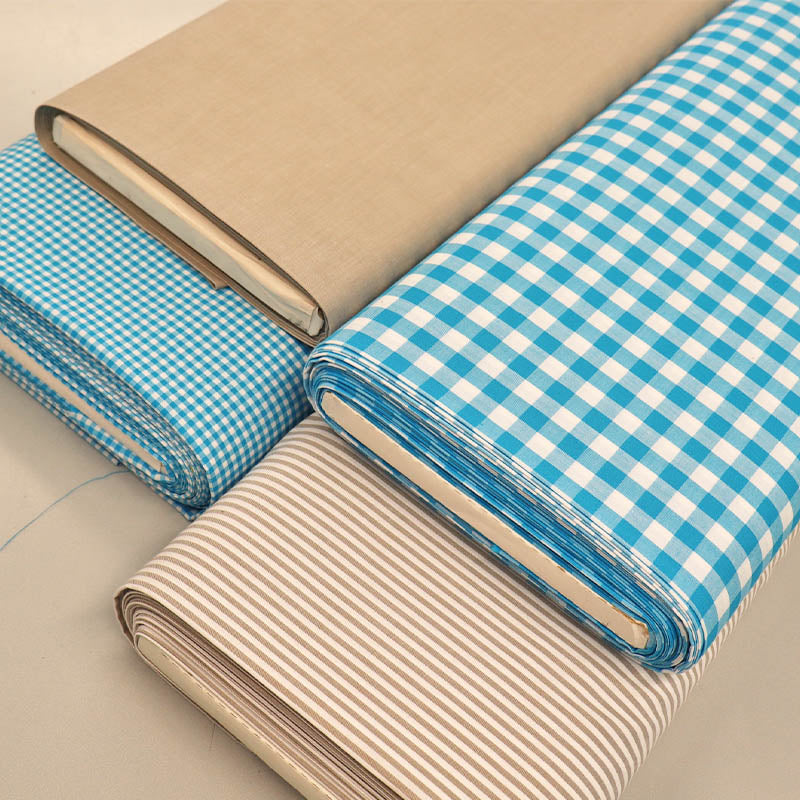 Blue gingham fabrics with plain brown and  brown striped chambray dressmaking fabrics