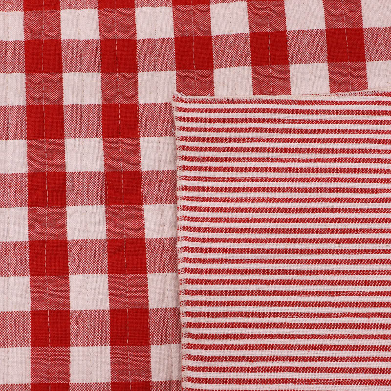 Pre quilted 100% cotton fabric in a red gingham on one side and narrow red and white stripe on the reverse