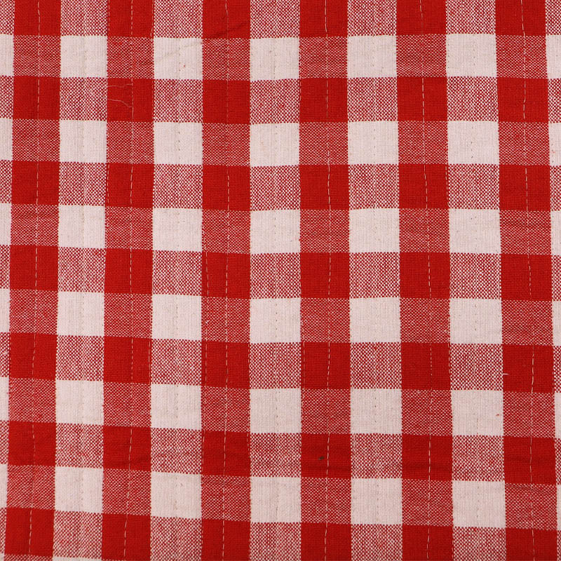 Pre quilted 100% cotton fabric in a red gingham on one side and narrow red and white stripe on the reverse