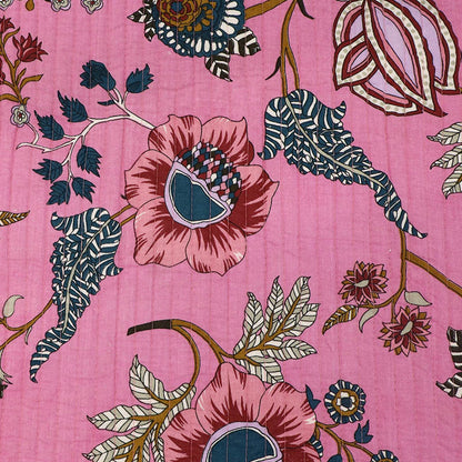 Pink quilted 100% Indian cotton fabric with a detailed floral and botanical print featuring pink poppies, navy blue leaves, and brown stems.