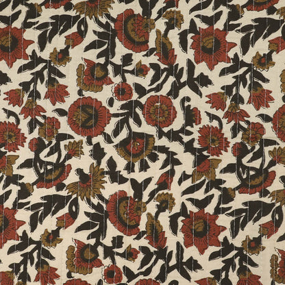 Quilted 100% Indian cotton fabric with a floral design in red, brown and black on a cream background on one side and a fine red and brown stripe on the reverse.
