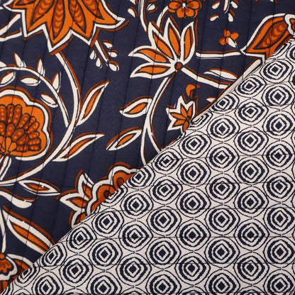 100% Cotton with Polyester Wadding QUILTED Cotton Fabric - Navy and Orange Floral with geometric navy and cream circular design on reverse