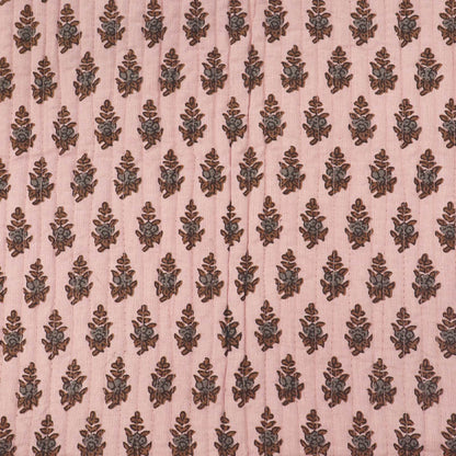 Quilted 100% Indian cotton fabric with a floral motif in brown and grey on a pale pink background 
