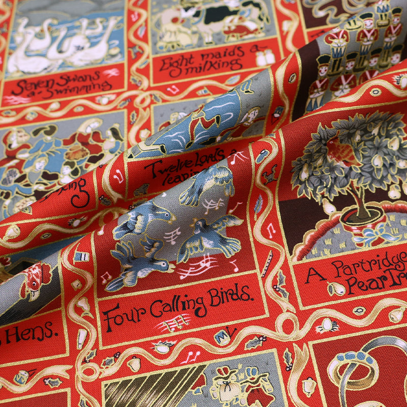 Christmas fabric panel in red featuring images from the 12 days of xmas