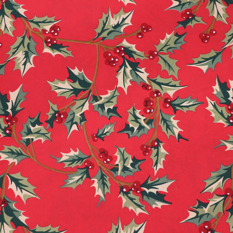 Red cotton Christmas fabric with green holly and berry print
