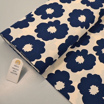  100% Viscose Floral Viscose Fabric featuring a bold modern floral in dark blue on a cream background. 
