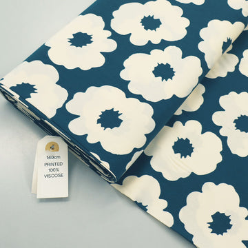 100% Viscose Floral Viscose Fabric featuring a bold modern floral in cream on a petrol blue-green background